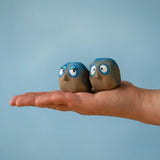 Large Bumbu handcrafted wooden love birds in adult hand