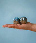 Large Bumbu handcrafted wooden love birds in adult hand