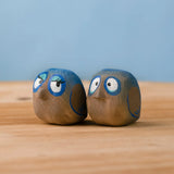 Bumbu hand crafted large wooden love birds figure set standing on a wooden surface.