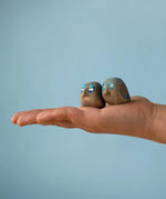 Medium Bumbu handcrafted wooden love birds in adult hand