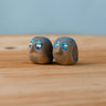Bumbu hand crafted medium wooden love birds figure set standing on a wooden surface.