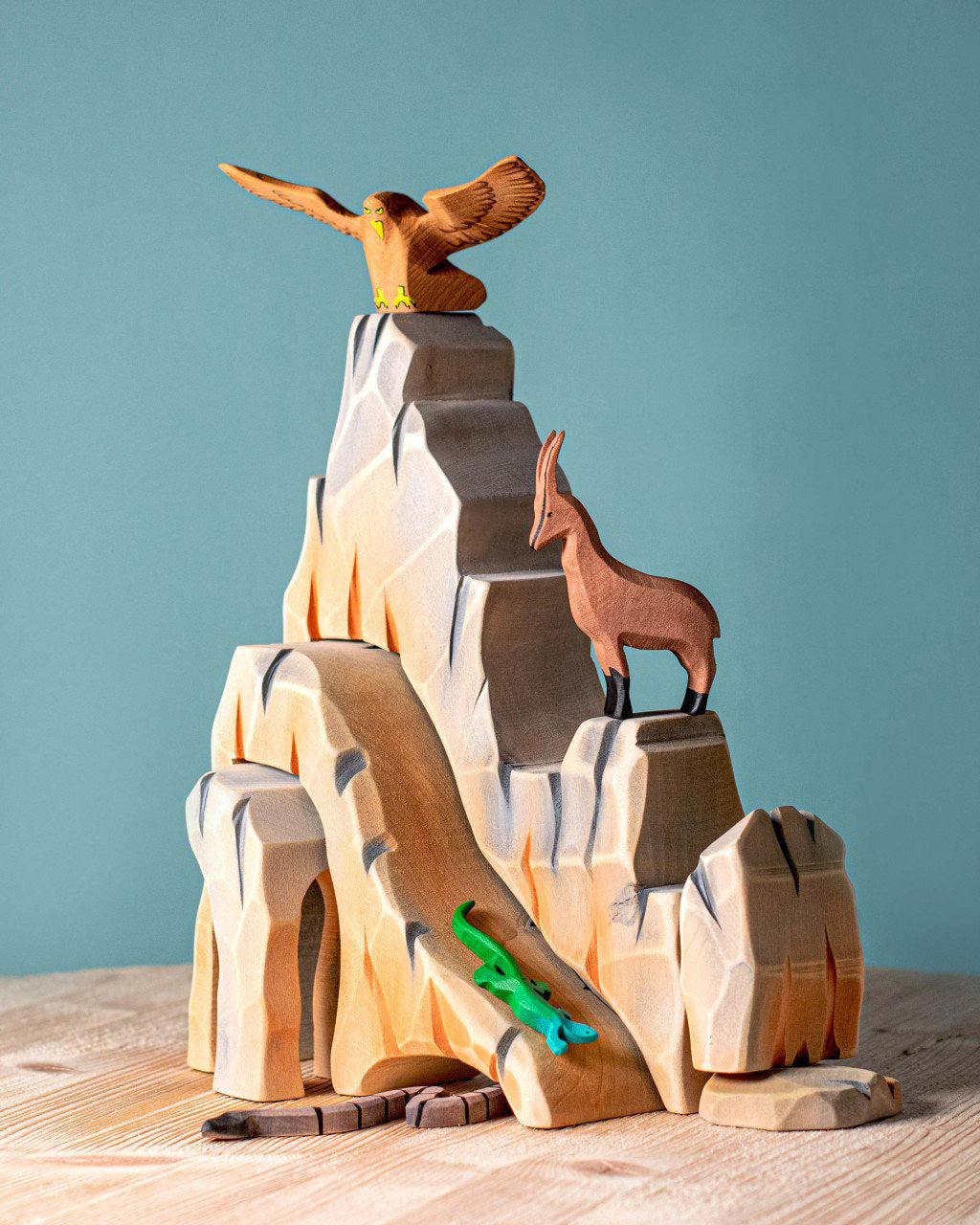 Five-piece Bumbu Mountain Cliffs set made from hand-carved, hand-painted wood. The pieces form tall, rocky cliffs for small-world play. Available at Babipur.