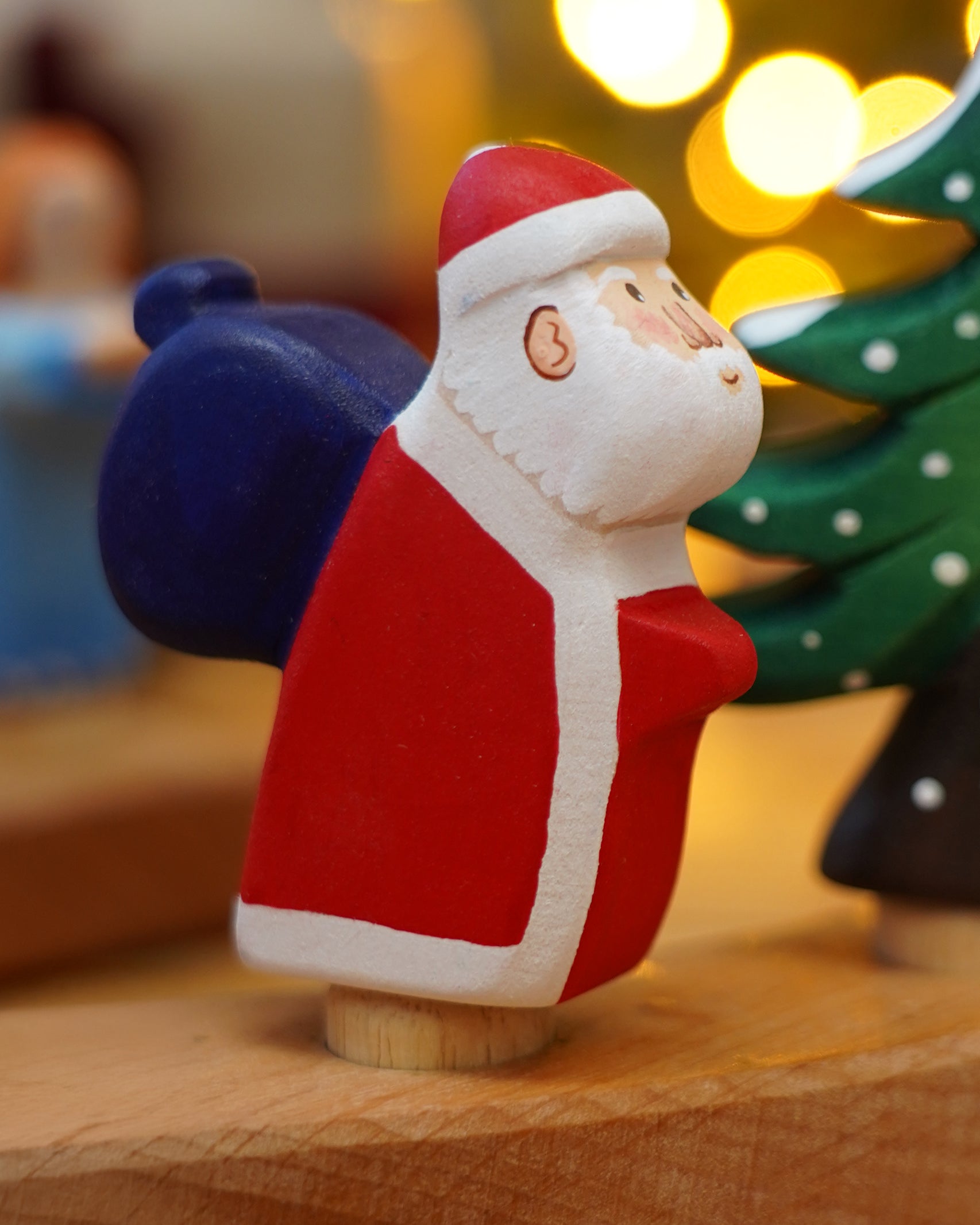 Wooden Bumbu Santa Celebration Ring Figure, this Father Christmas is compatible with the Grimm's Ring - add to a winter display or use as a toy - for sale at Babipur.
