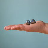 Small Bumbu handcrafted wooden love birds in adult hand