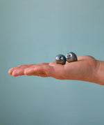 Small Bumbu handcrafted wooden love birds in adult hand