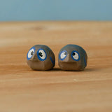 Bumbu hand crafted small wooden love birds figure set standing on a wooden surface.