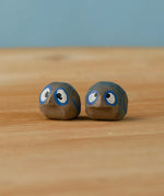 Bumbu hand crafted small wooden love birds figure set standing on a wooden surface.