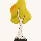 A small wooden Bumbu birch tree on a plain background.