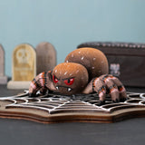 Bumbu handmade and hand painted wooden spider figure with hand painted facial features resting on a wooden Bumbu cobweb in a spooky play scene