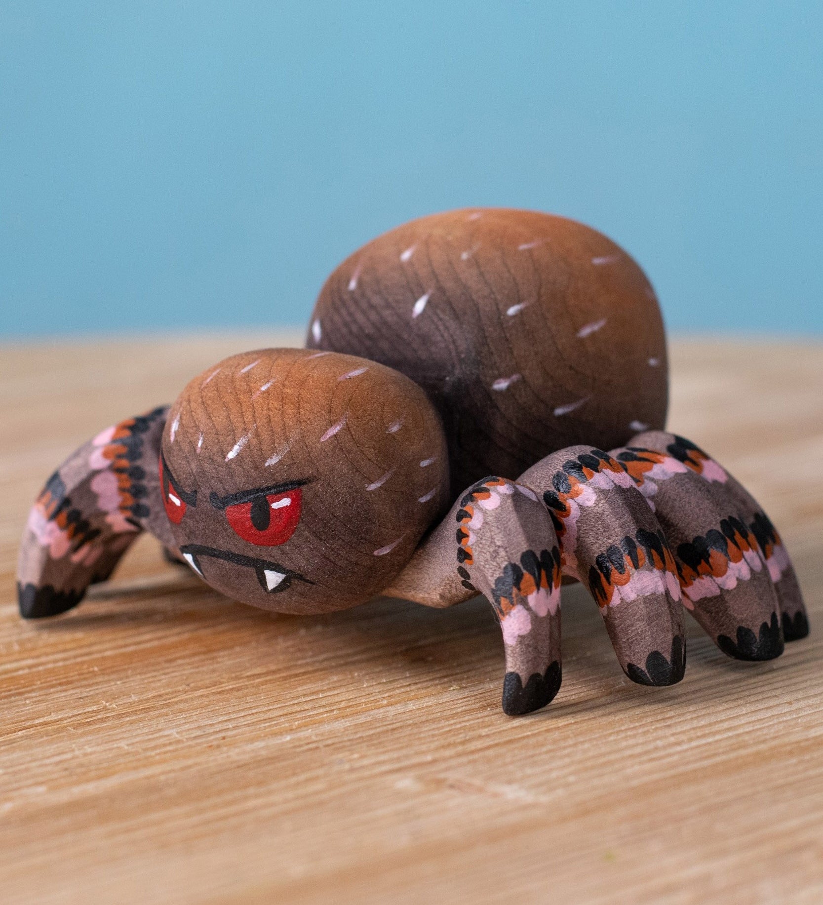 Bumbu handmade and hand painted wooden spider figure with hand painted facial features available at Babipur.