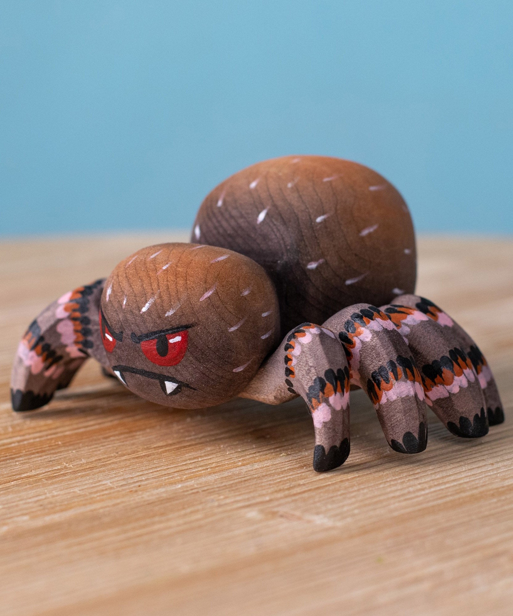 Bumbu handmade and hand painted wooden spider figure with hand painted facial features available at Babipur.
