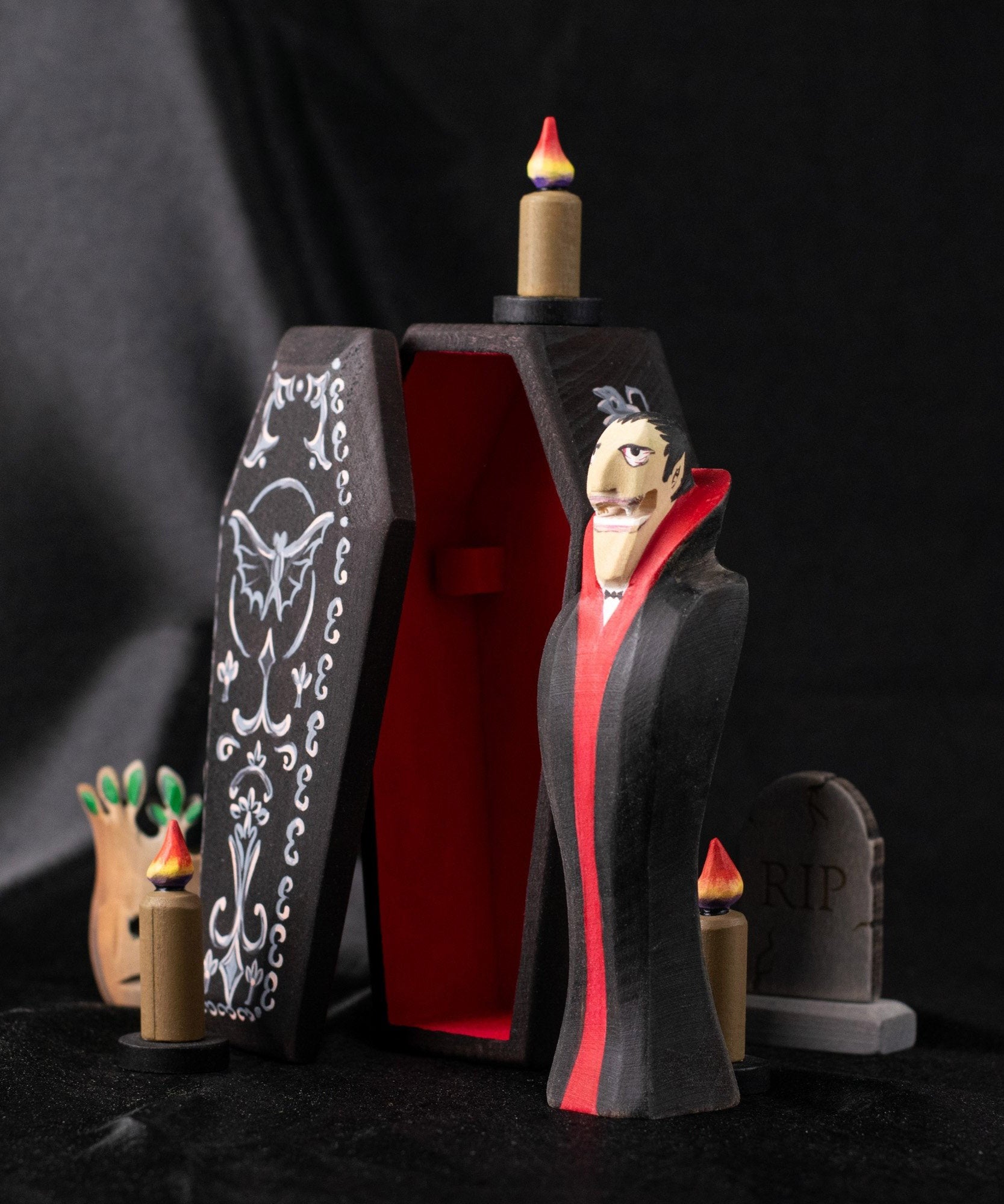 Bumbu handmade and hand painted dracula the vampire figure in a spooky display including a coffin, candles, tree and tombstone available at Babipur.
