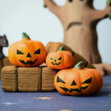 The small, medium and large Bumbu Toys Halloween Pumpkins are sat on Bumbu hay-bales, with the Bumbu scardy cat and and Bumbu large spooky tree in the background. Each pumpkin is hand made and hand painted