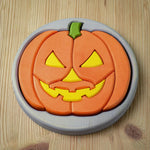 The Bumbu Toys Halloween Pumpkin Puzzle - Grey, laid on a wooden table