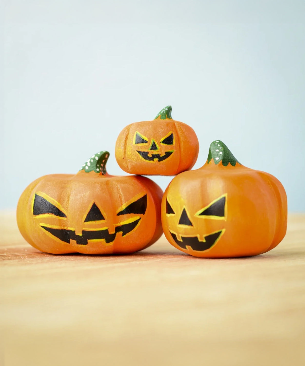 The small, medium and large Bumbu Toys Halloween Pumpkins stacked on each other. This image gives a close up of the pumpkin texture and paintwork on each pumpkin