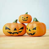 The small, medium and large Bumbu Toys Halloween Pumpkins stacked on each other. This image gives a close up of the pumpkin texture and paintwork on each pumpkin