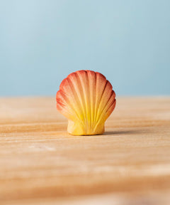 Bumbu handmade and hand painted orange and red wooden seashell figure with shell details available at Babipur. 