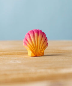 Bumbu handmade and hand painted orange and pink wooden seashell figure with shell details available at Babipur. 