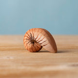 Bumbu handmade and hand painted brown wooden spiral shell figure with shell details available at Babipur. 