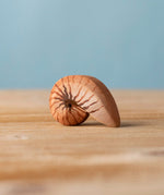 Bumbu handmade and hand painted brown wooden spiral shell figure with shell details available at Babipur. 