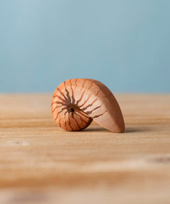 Bumbu handmade and hand painted brown wooden spiral shell figure with shell details available at Babipur. 