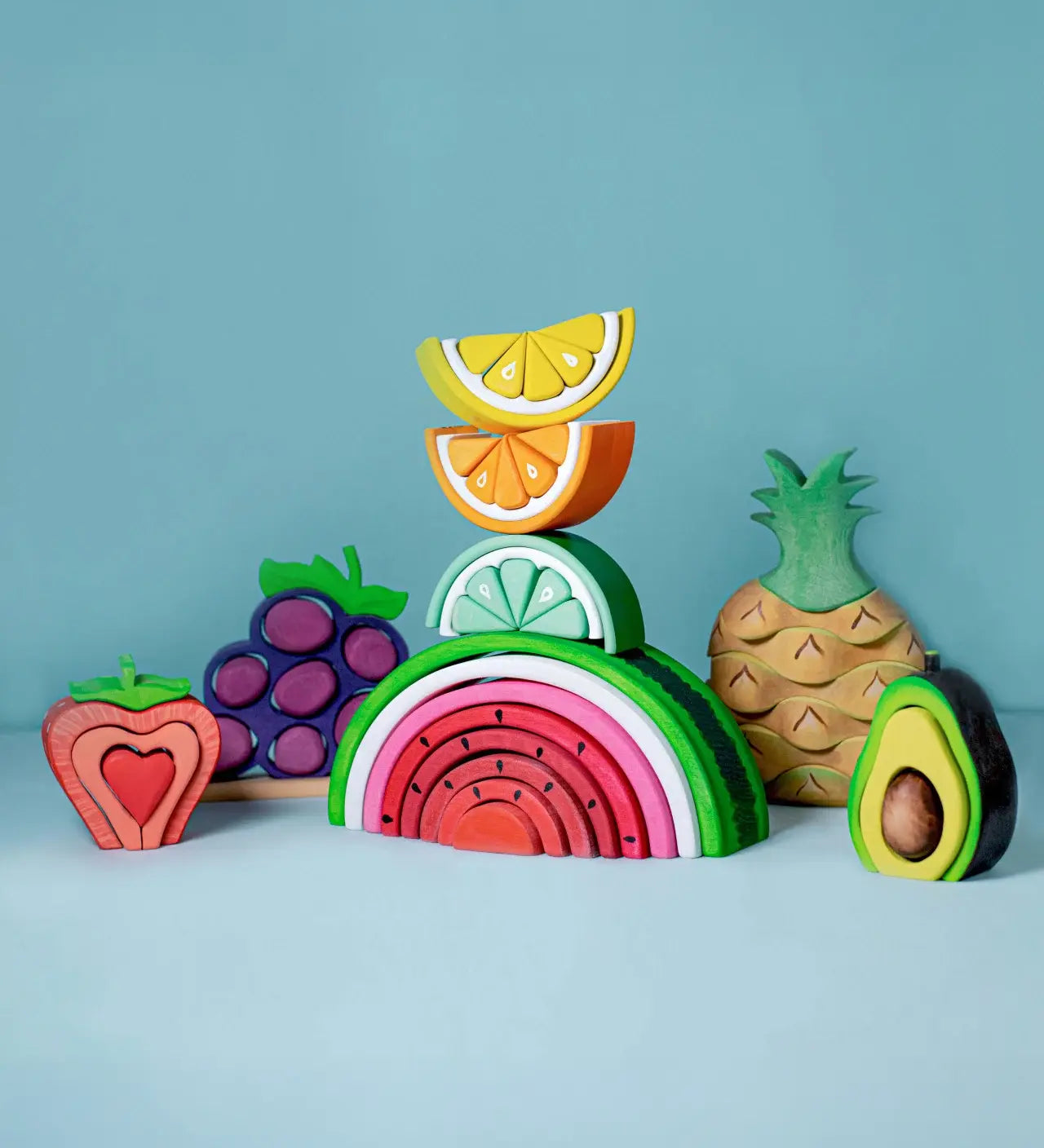 Bumbu Toys wooden Lemon, Lime, Orange and Watermelon stacking toys arranged together.