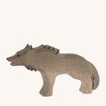 Bumbu wooden angry wolf figure on a plain background.