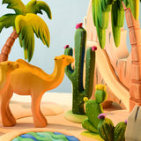 The Bumbu Wooden Saguaro Cactus Figure with red flowers in a desert oasis play scene