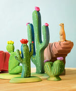 The Bumbu Wooden Saguaro Cactus Figure with red flowers in the foreground