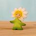 Bumbu handcrafted wooden daisy flower child figure with hand painted facial features standing on a wooden surface
