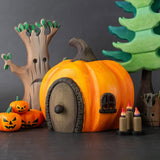 Bumbu handmade and hand painted wooden orange Halloween pumpkin house with other Bumbu spooky inspired figures including pumpkins, candles and a spooky tree available at Babipur.