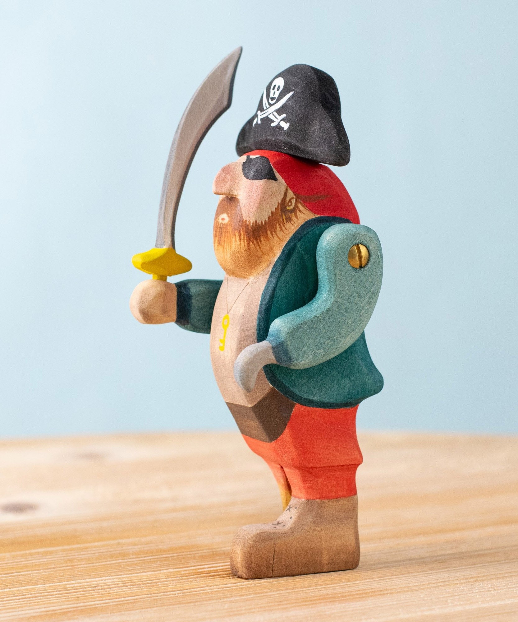 Bumbu handmade and hand painted pirate wooden figure available at Babipur showing the movable arm and hand painted detail