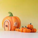 Bumbu handmade and hand painted wooden orange pumpkin house with small Bumbu pumpkin figures available at Babipur.
