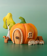 Bumbu handmade and hand painted wooden orange pumpkin house with other Bumbu woodland inspired figures including hedgehogs, a squirrel and a birch tree set available at Babipur.