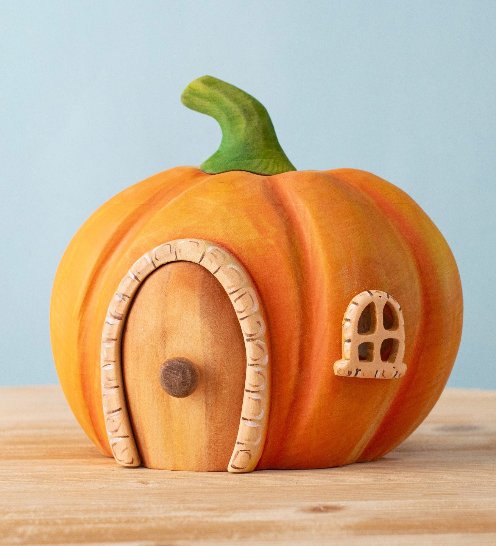 Bumbu handmade and hand painted wooden orange pumpkin house available at Babipur. Features a cute window and a removable door.