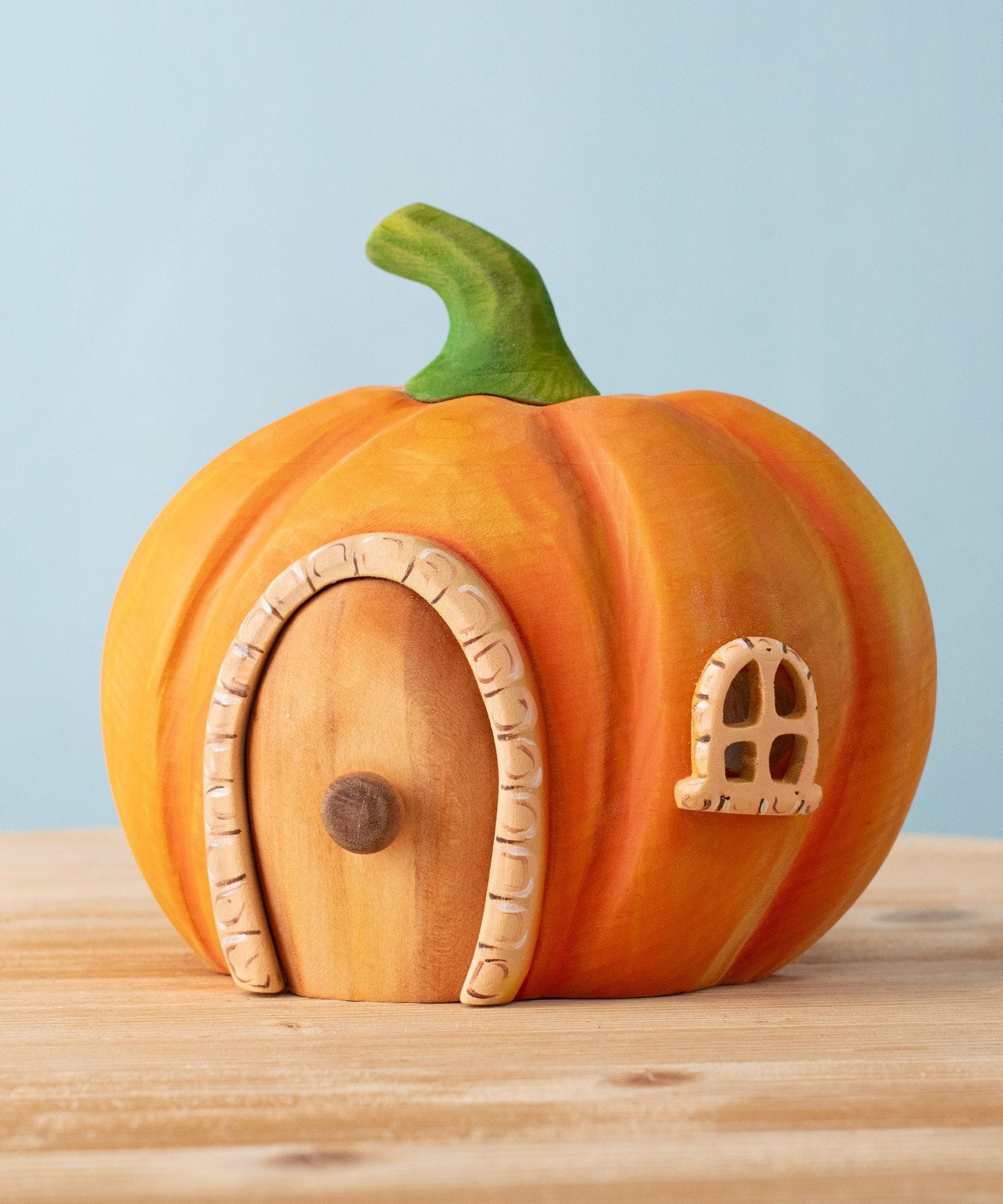 Bumbu handmade and hand painted wooden orange pumpkin house available at Babipur. Features a cute window and a removable door.