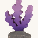 Bumbu wooden purple seaweed figure on a plain background.
