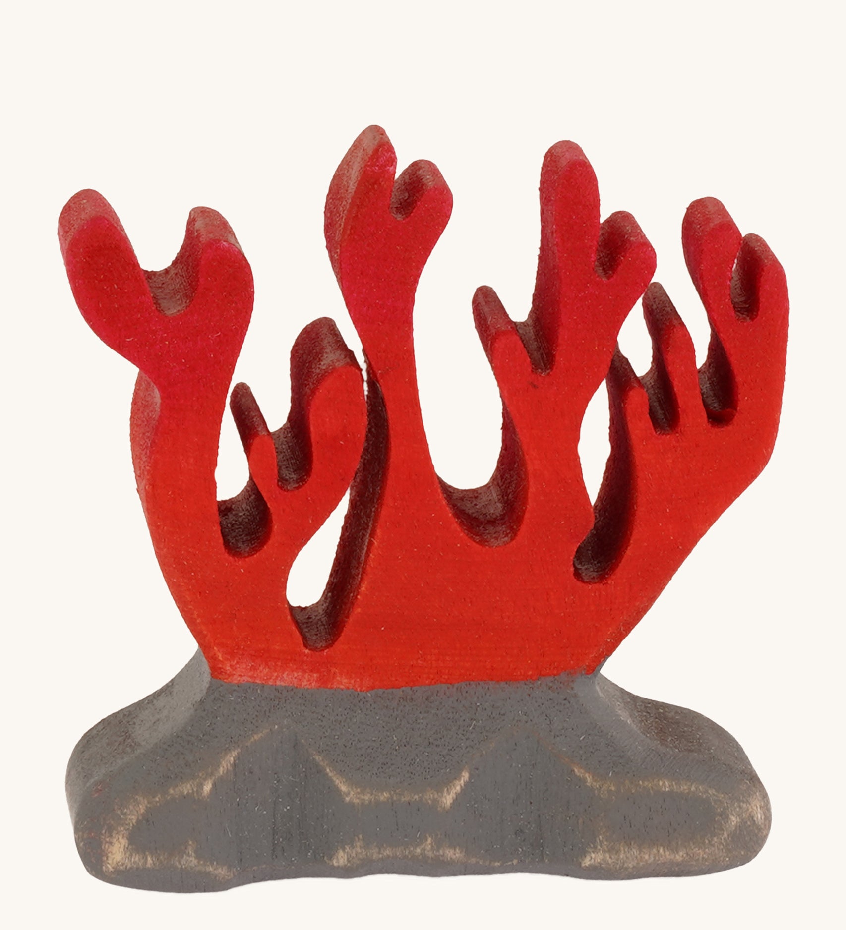 Bumbu wooden red coral toy figure on a plain background.