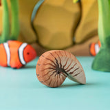 Bumbu handmade and hand painted brown wooden spiral shell figure with a clownfish and reef set in the background