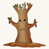 Bumbu wooden spooky tree with facial features on the trunkon a plain background