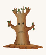 Bumbu wooden spooky tree with facial features on the trunkon a plain background