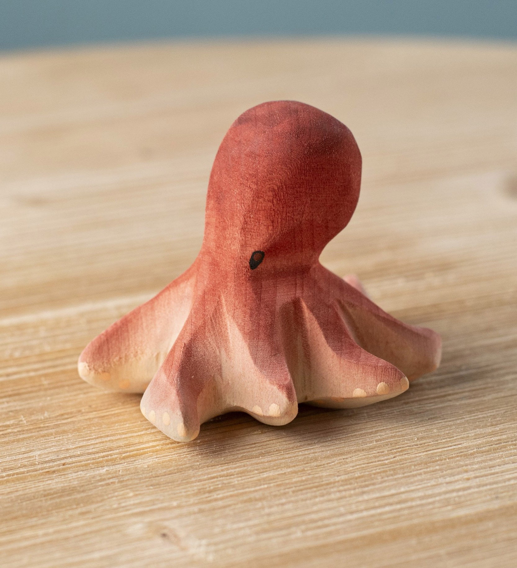 Bumbu handmade and hand painted wooden red octopus figure with cute facial features available at Babipur