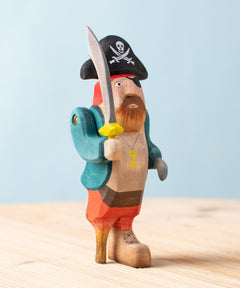 Bumbu handmade and hand painted pirate wooden figure available at Babipur. Wearing a blue coat, red trousers and a black hat. Features a sword and a wooden leg