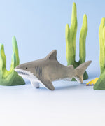 Bumbu handmade and hand painted wooden grey shark surrounded by the Bumbu green coral figures