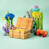 Bumbu handmade and hand painted wooden treasure chest in a deep sea playscene which includes various under the sea themed animal figures