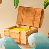 Bumbu handmade and hand painted wooden treasure chest in a ocean playscene which includes palm trees and ocean waves.