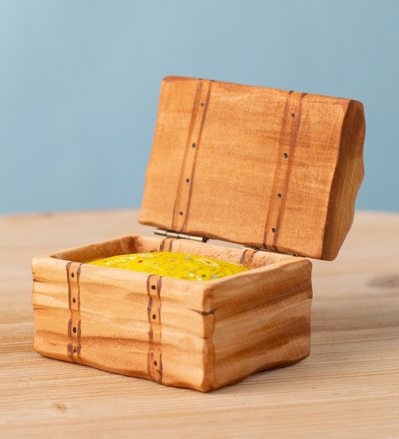 Bumbu handmade and hand painted wooden treasure chest available at Babipur. Features a lid with hinges and decorative gold inside
