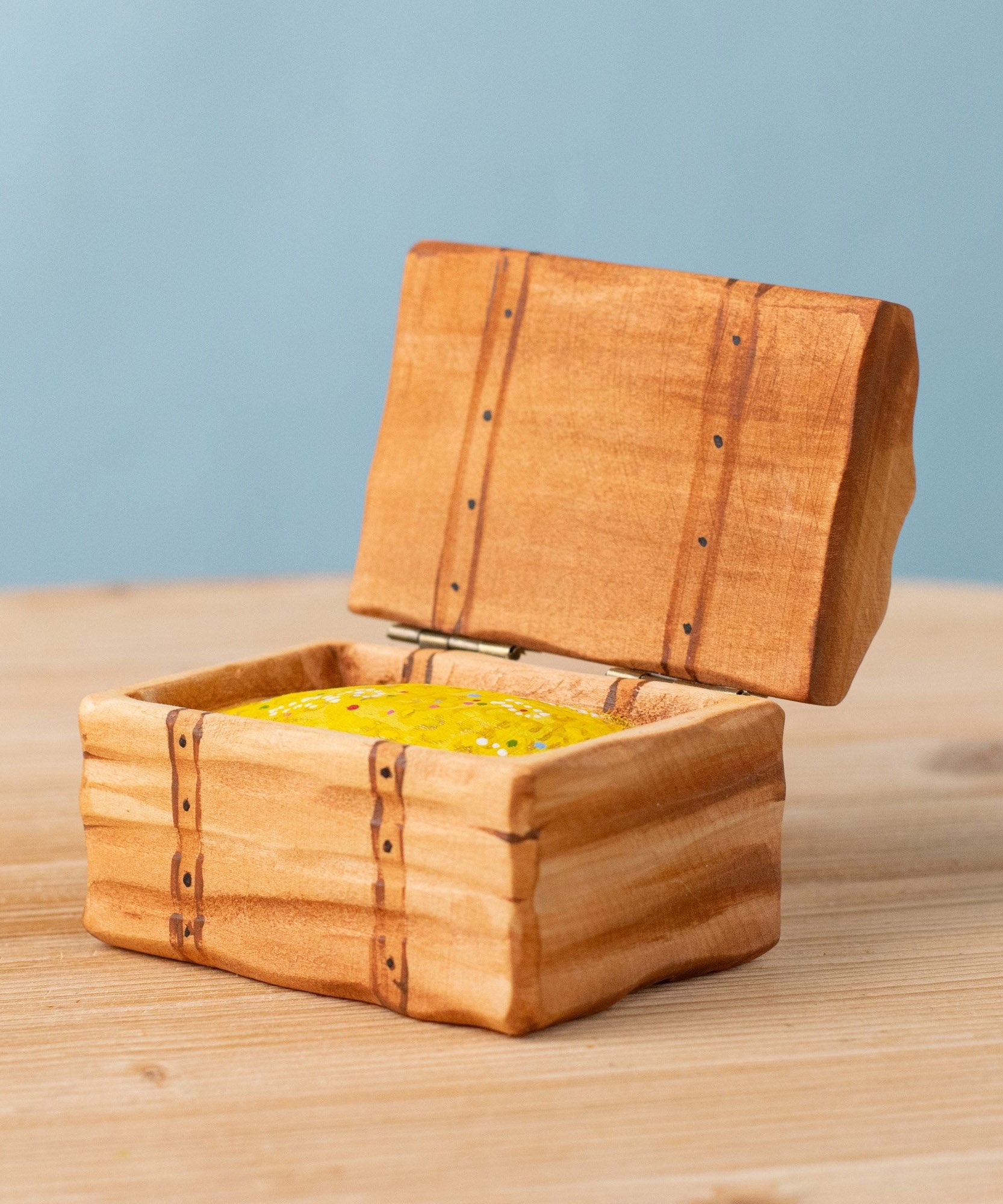 Bumbu handmade and hand painted wooden treasure chest available at Babipur. Features a lid with hinges and decorative gold inside