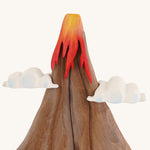 A close up of the A Bumbu volcano wooden toy on a plain background.