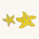 Bumbu yellow wooden starfish set on a plain background. 